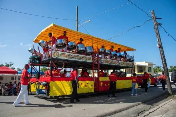 Steel drum band performing on a colourful float during a street parade