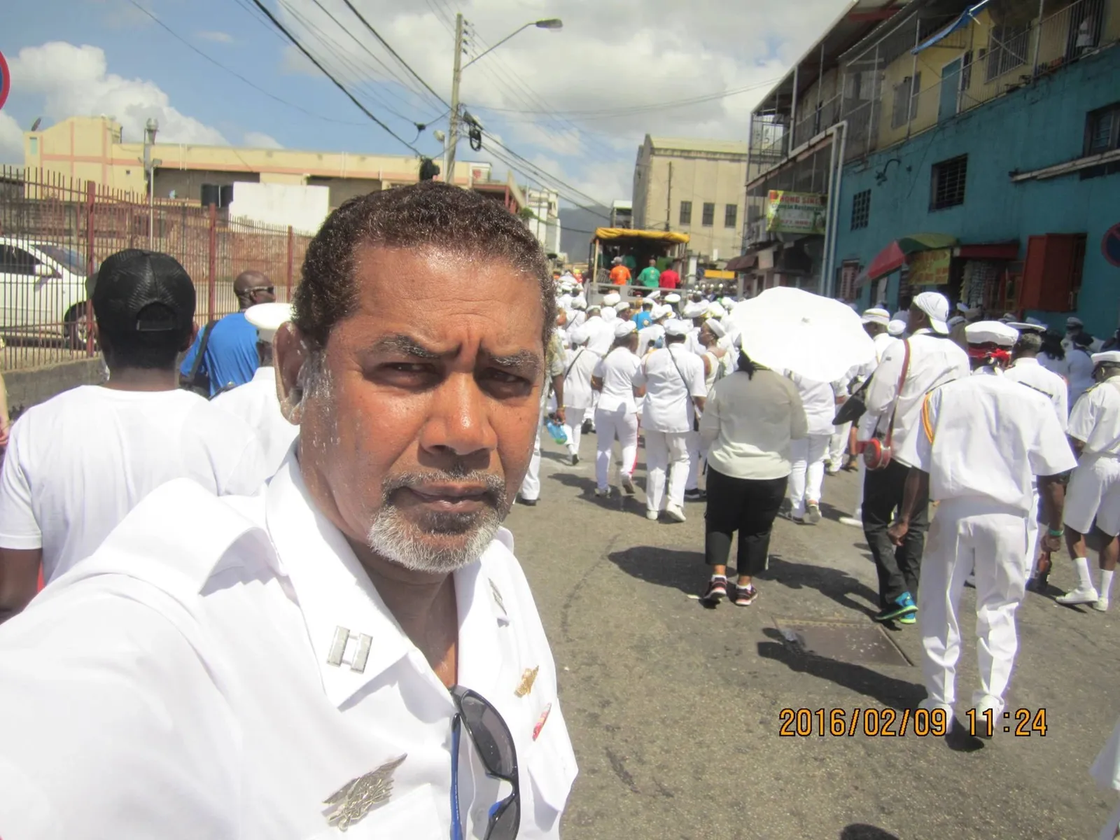 Jesse Andrews in a white shirt during a Carnival procession